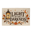 Light in the Darkness Christian Halloween welcome mat with a glowing cross lantern and crescent moon