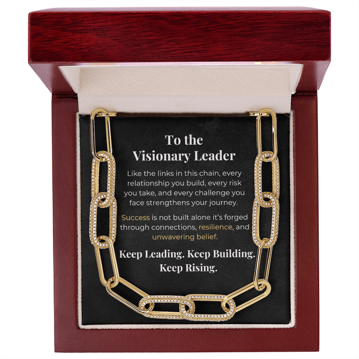 Gold chain necklace in mahogany gift box with inspirational message for visionary leaders about building connections and rising to challenges.