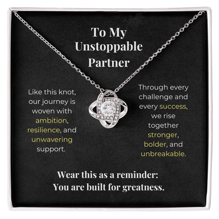 Silver love knot necklace with crystal pendant in gift box, featuring inspirational message for unstoppable partners about ambition, resilience and shared success.